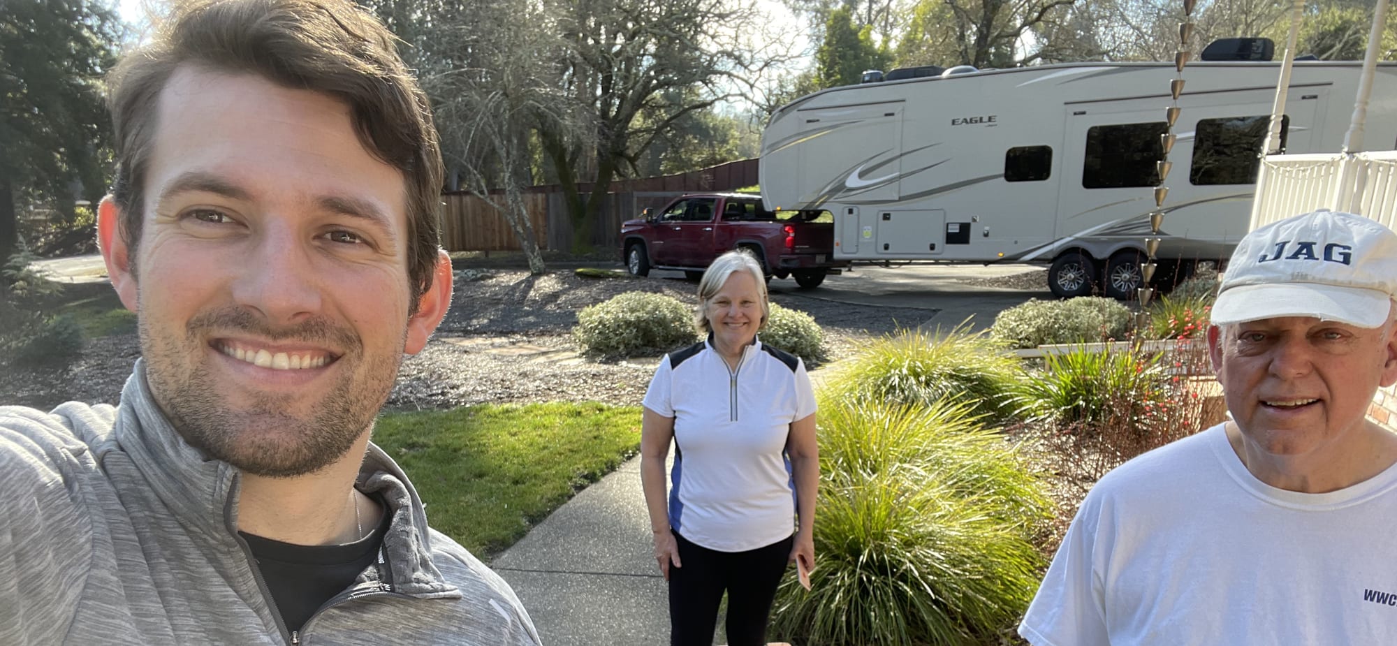 John and his parents beside the truck and fifth-wheel at his family's home in California.